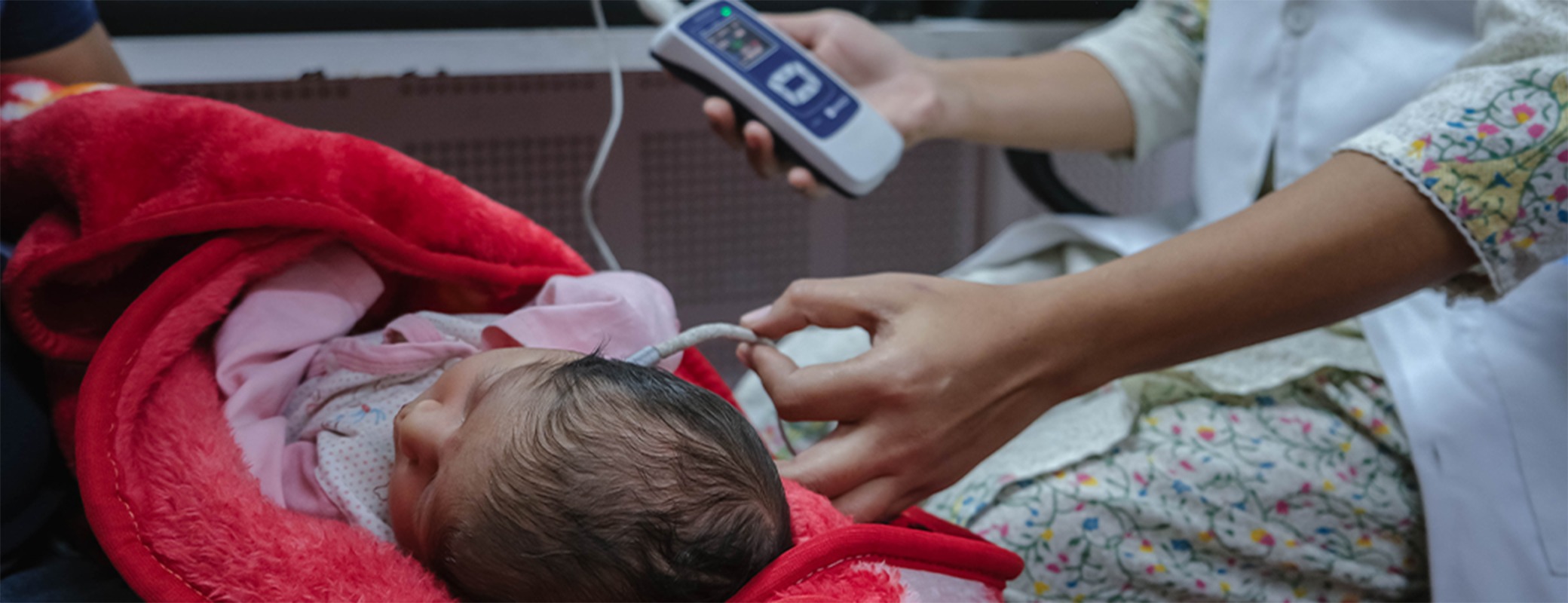 Image of infant getting a hearing screening